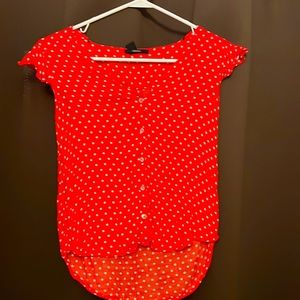 Red polka dot button up short sleeve shirt with slightly ruffled sleeves.